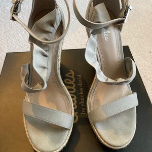 Light gray sandals with ruffles.